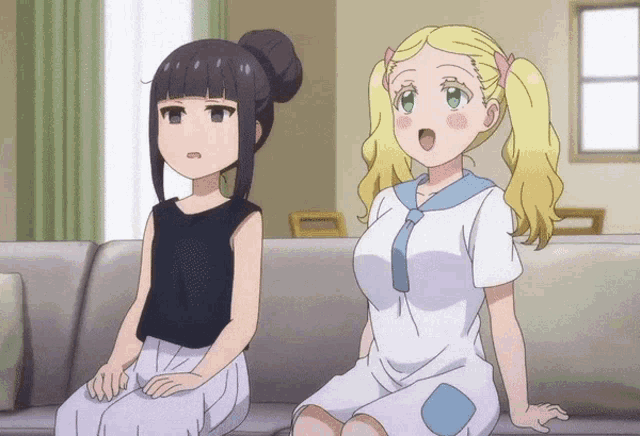 two anime girls are sitting on a couch and one has her mouth open