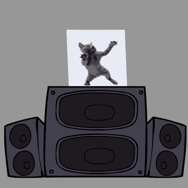 a picture of a cat standing on its hind legs behind a speaker