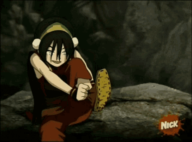 a cartoon character sitting on a rock with a nick logo on the bottom right