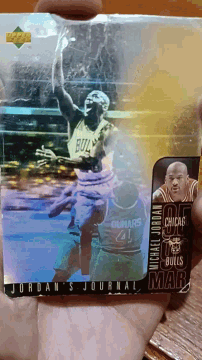 a jordan 's journal basketball card is being held in someone 's hand