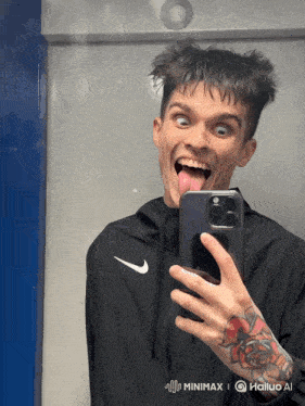 a man is taking a picture of himself in a mirror with his tongue hanging out