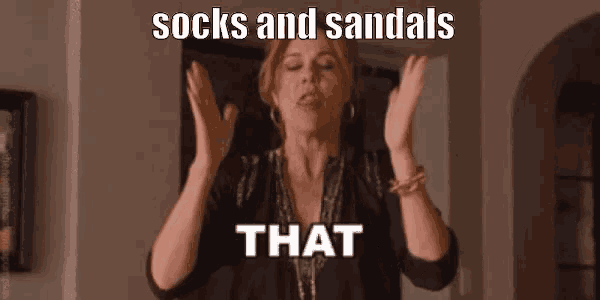 a woman is making a funny face while wearing socks and sandals and that .
