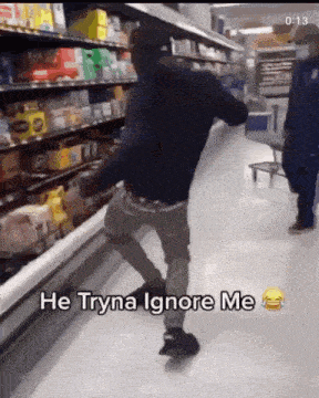 a man dancing in a grocery store with the words he tryna ignore me