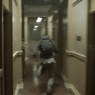 a blurry photo of a person running down a hall