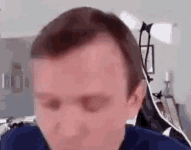 a close up of a man 's face with his eyes closed while sitting in a chair .