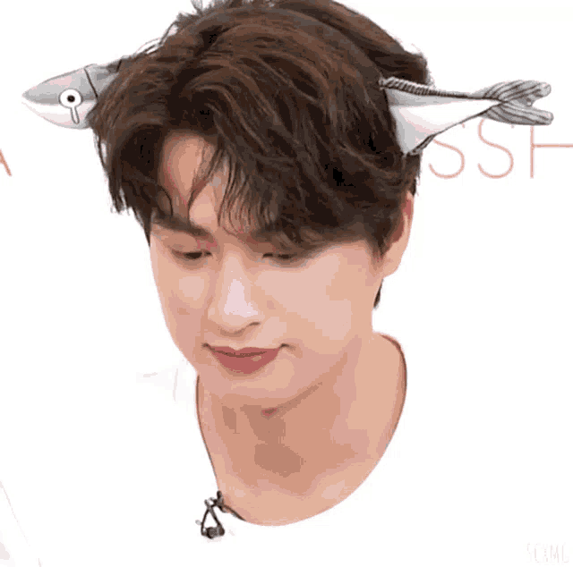 a man wearing a headband that looks like a fish with the word ssh in the background