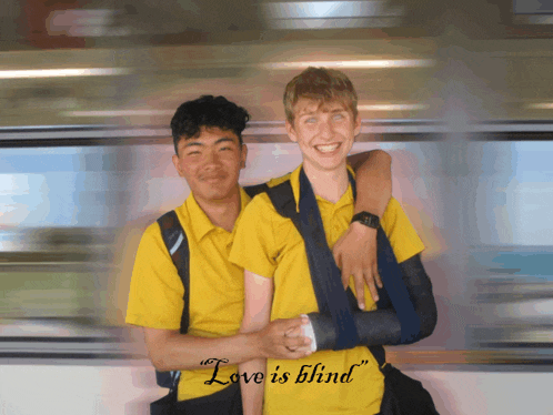 a man with a broken arm is being held by another man with a yellow shirt that says love is blind