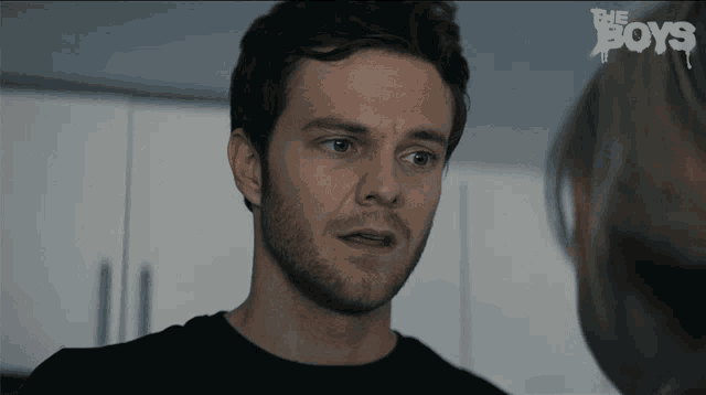 a close up of a man 's face with the words " the boys " behind him
