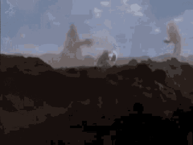 a group of people are standing on top of a pile of dirt .
