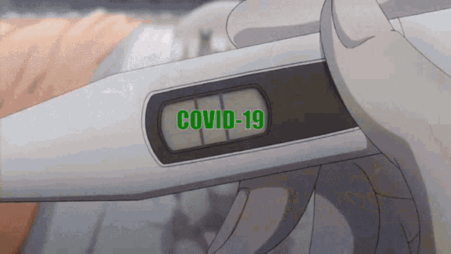 a person is holding a thermometer that says covid-19 on the screen