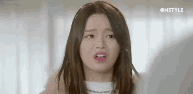 a woman is making a funny face with her mouth open .