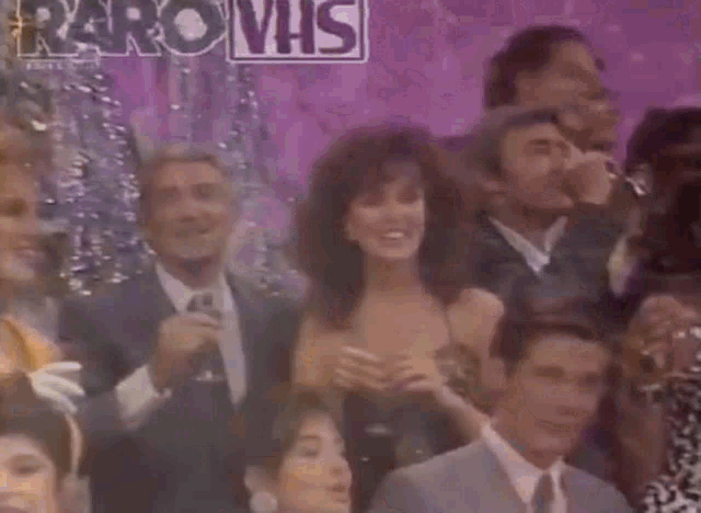a group of people are gathered in front of a sign that says raro vhs