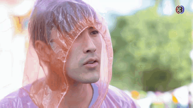 a man wearing a plastic bag over his head with the number 3 on the bottom