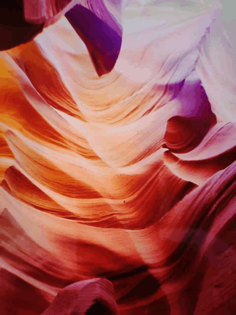 a painting of a canyon with a purple and orange colored swirl