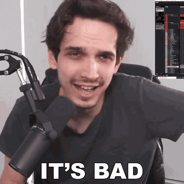 a man holding a microphone with the words " it 's bad " on the bottom