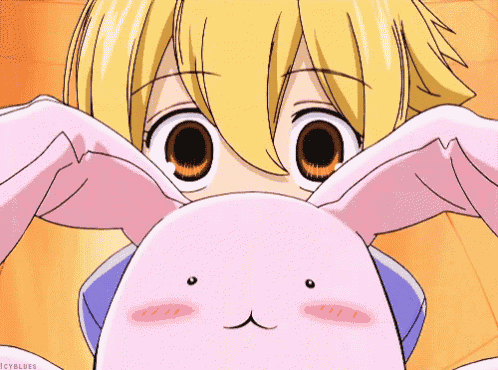 a close up of a girl holding a pink bunny rabbit