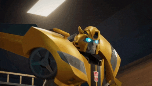 a yellow robot with blue eyes and a transformers logo