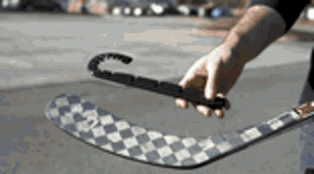a person is holding a hockey stick in their hand with a broken handle .