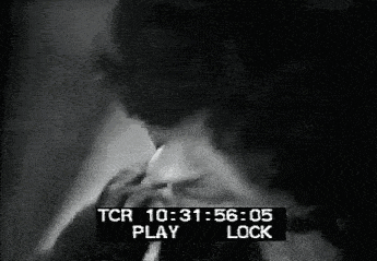 a black and white photo of a man smoking a cigarette with a tcr play and lock screen