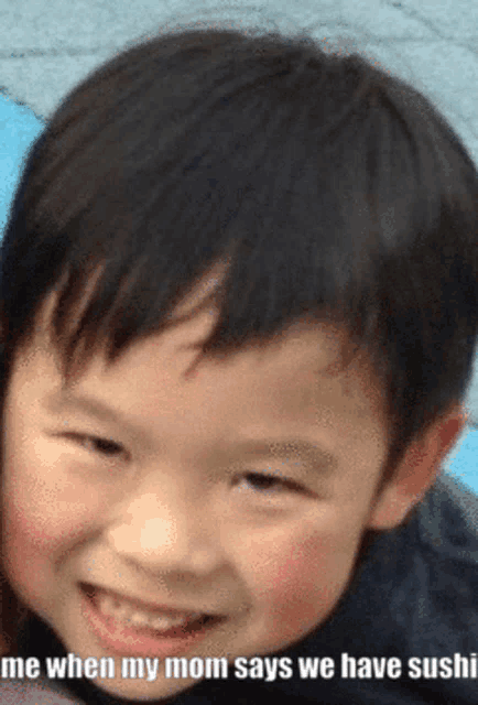 a young boy is smiling with a caption that reads me when my mom says we have sushi