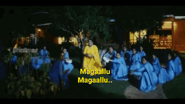 a woman in a yellow saree stands in front of a group of women in blue dresses with the words magaallu magaallu