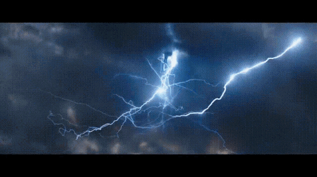 a lightning bolt strikes the ground in the dark sky