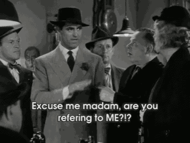 a group of men are standing in a room and one of them says excuse me madam are you refering to me ?