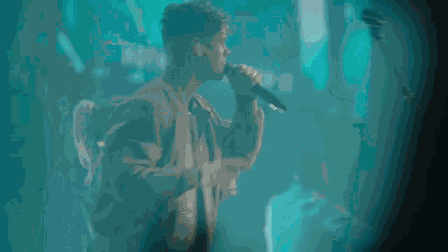 a crowd of people at a concert with the words " you are t " on the screen