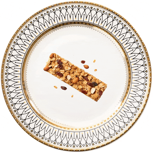 a plate with a granola bar on it and a gold border