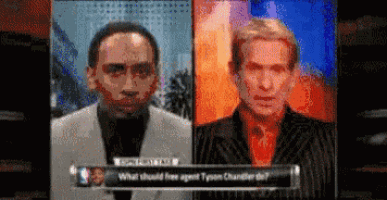 two men are standing next to each other in front of a sign that says what should free agent tyson chandler do ?