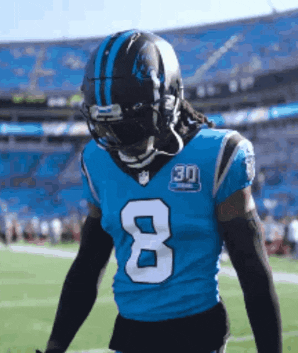 a football player is wearing a blue jersey with the number 8 on it