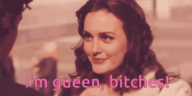 a woman says " i 'm queen bitches " in pink letters