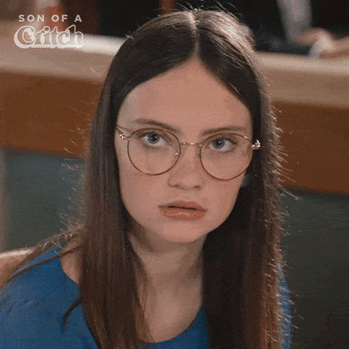 a close up of a woman wearing glasses with the words son of a critch behind her