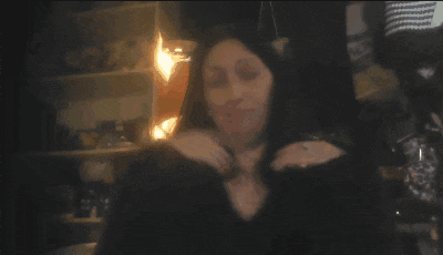 a blurry picture of two women standing next to each other in a dark room