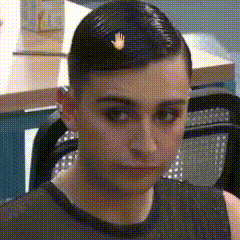 a close up of a person 's face with a hand on his head