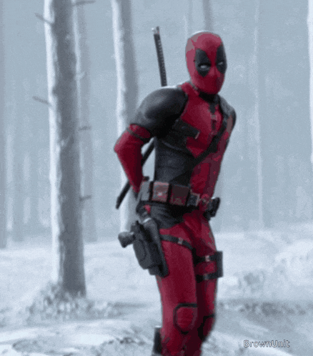 a deadpool standing in the snow with a sword
