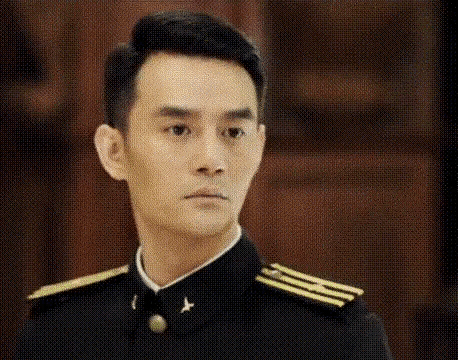 a young man in a military uniform is looking at the camera .
