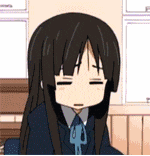 a girl with long black hair is making a sad face .