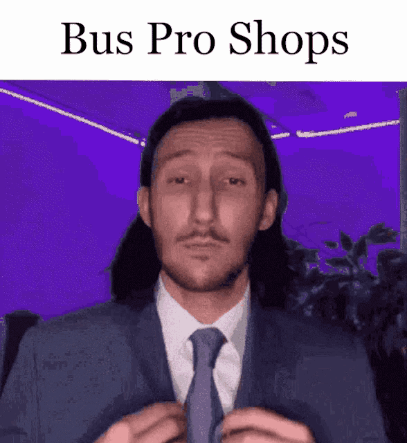 a man in a suit and tie adjusts his tie with the words bus pro shops above him