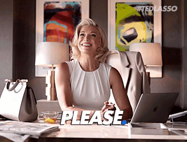 a woman sits at a desk with a sign that says please on it