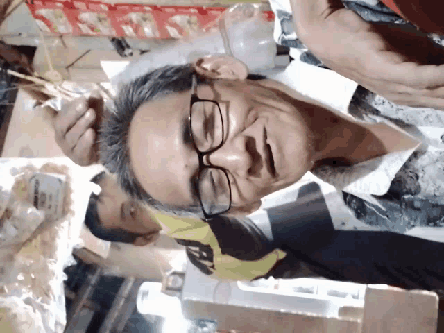 a man wearing glasses and a shirt with the number 9 on it