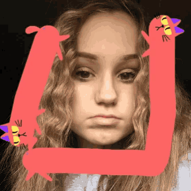 a girl with a drawing of a cat on her head