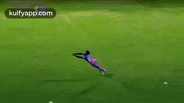 a person is flying through the air in a field .