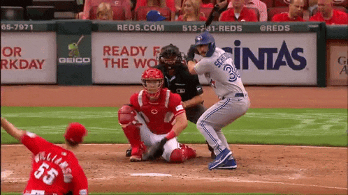 a baseball player with the number 55 on his back swings at a pitch