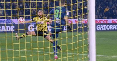 a soccer player in a yellow jersey with the number 91 on it