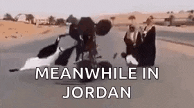 a group of people are riding a motorcycle on a road in the desert .
