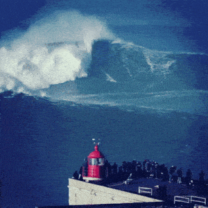 a group of people standing on top of a building watching a wave crash