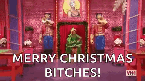 a woman in a green dress is standing in front of a room with christmas decorations .