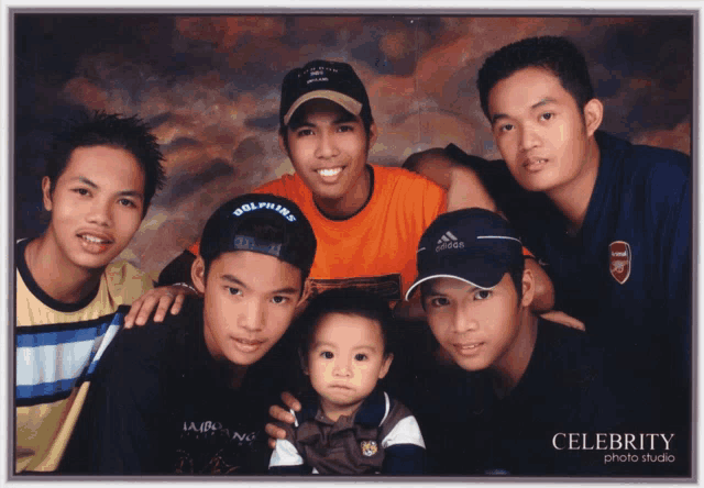 a group of young men posing for a photo with celebrity photo studio in the corner