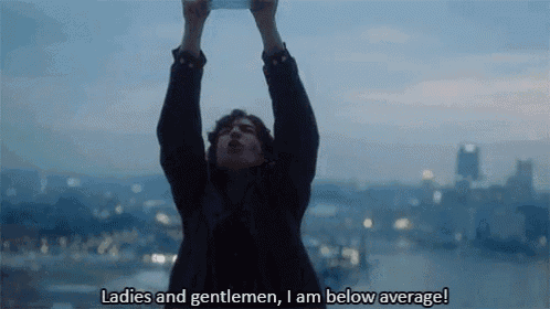 a man is holding a piece of paper in the air and says ladies and gentlemen i am below average .